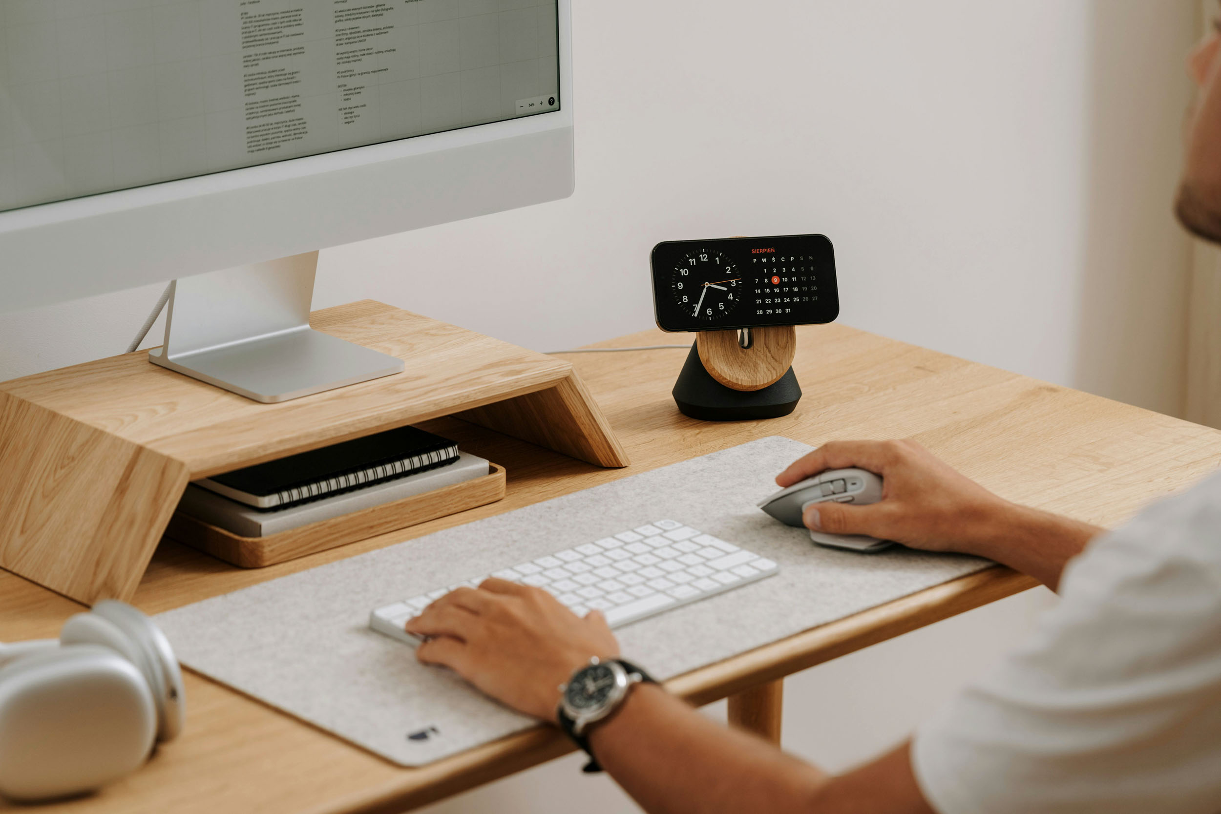 A man sits at a desk using a computer and mouse focused on his work 1