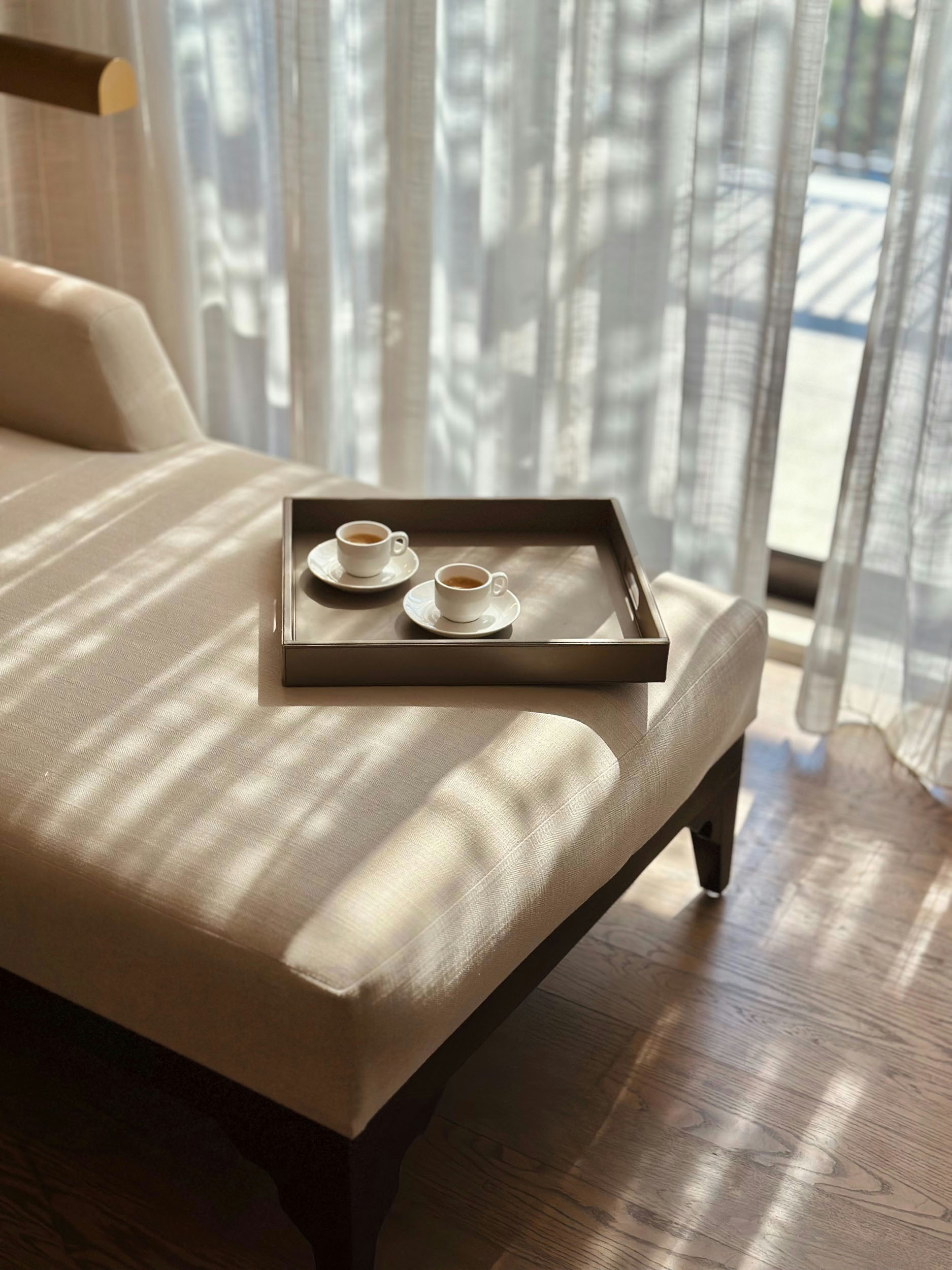 A tray with two steaming cups of coffee resting on a cozy bed inviting a relaxing morning moment 1