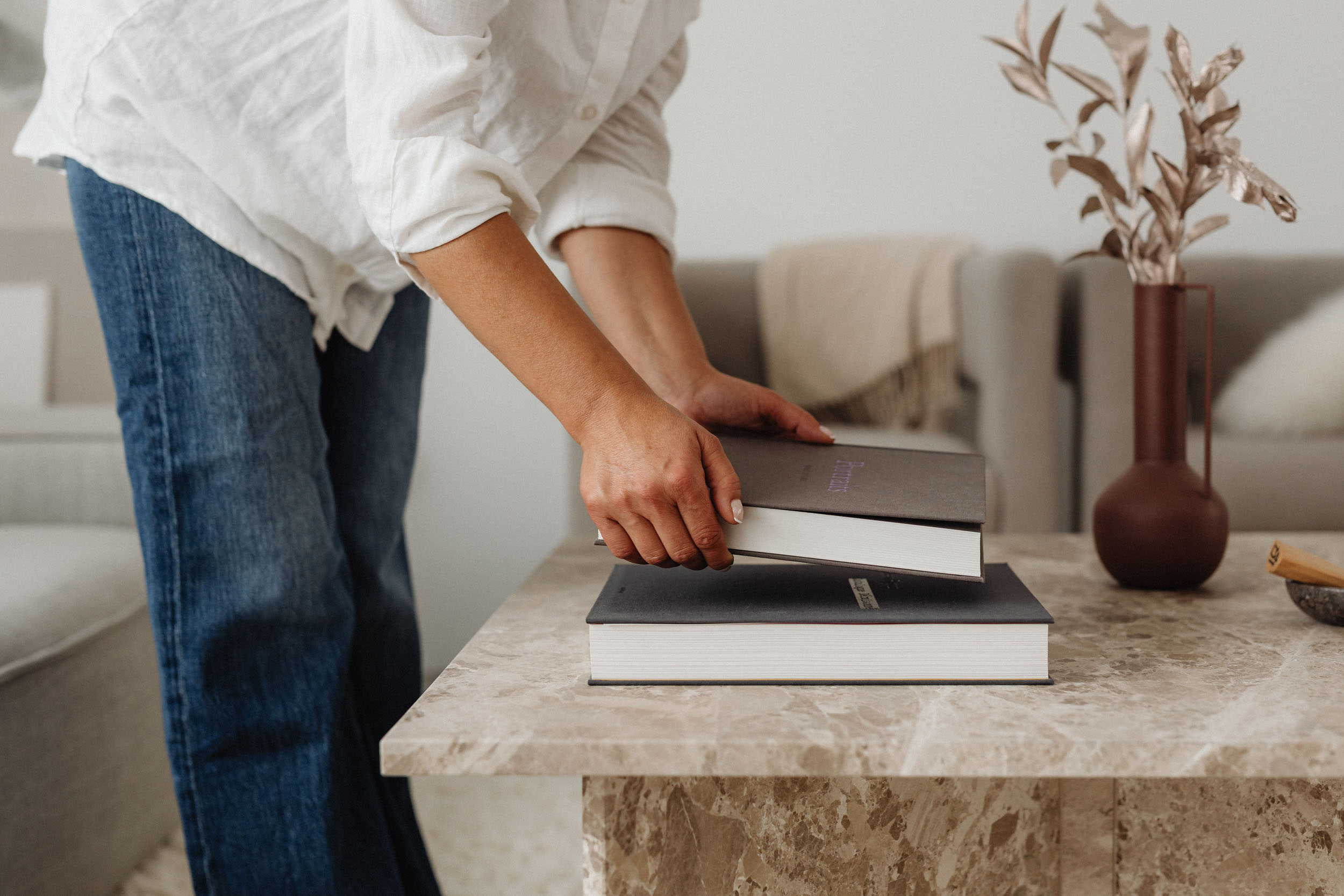 A woman holds a book on a table looking engaged and ready to read 1