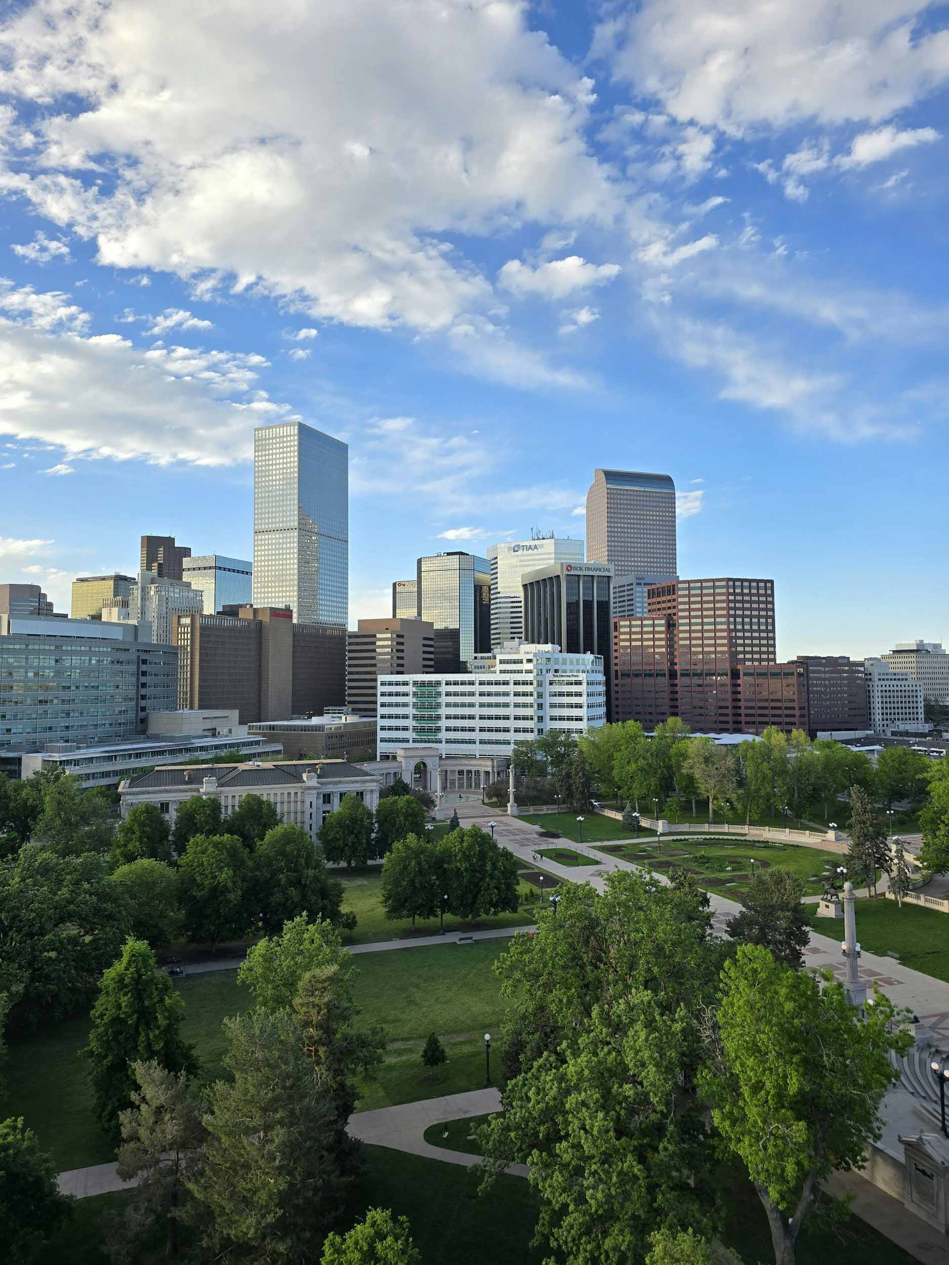 City skyline viewed from above showcasing tall buildings and urban layout against a clear blue sky 2