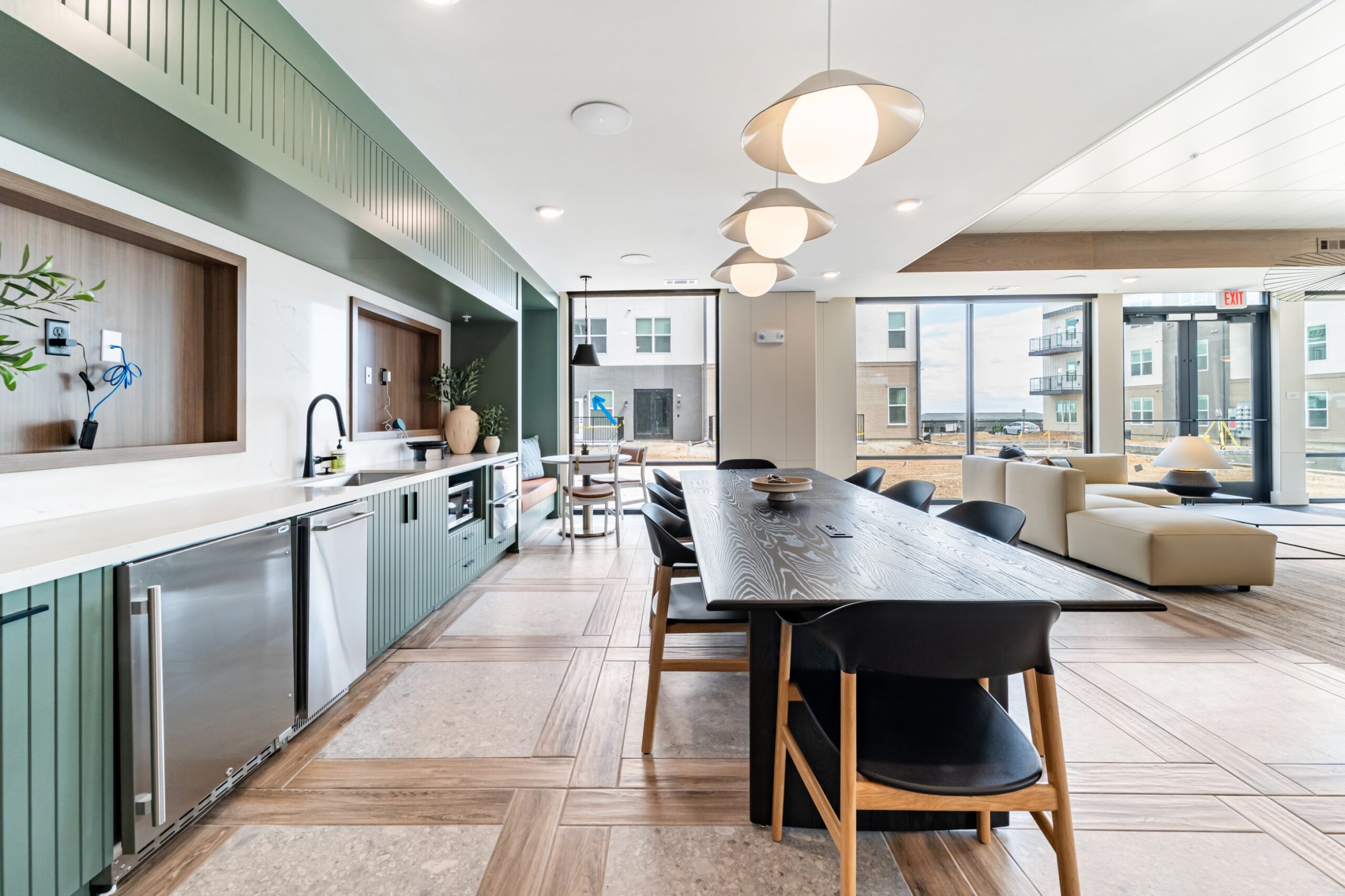 Community kitchen and long meeting or dining table at Banyan High Point
