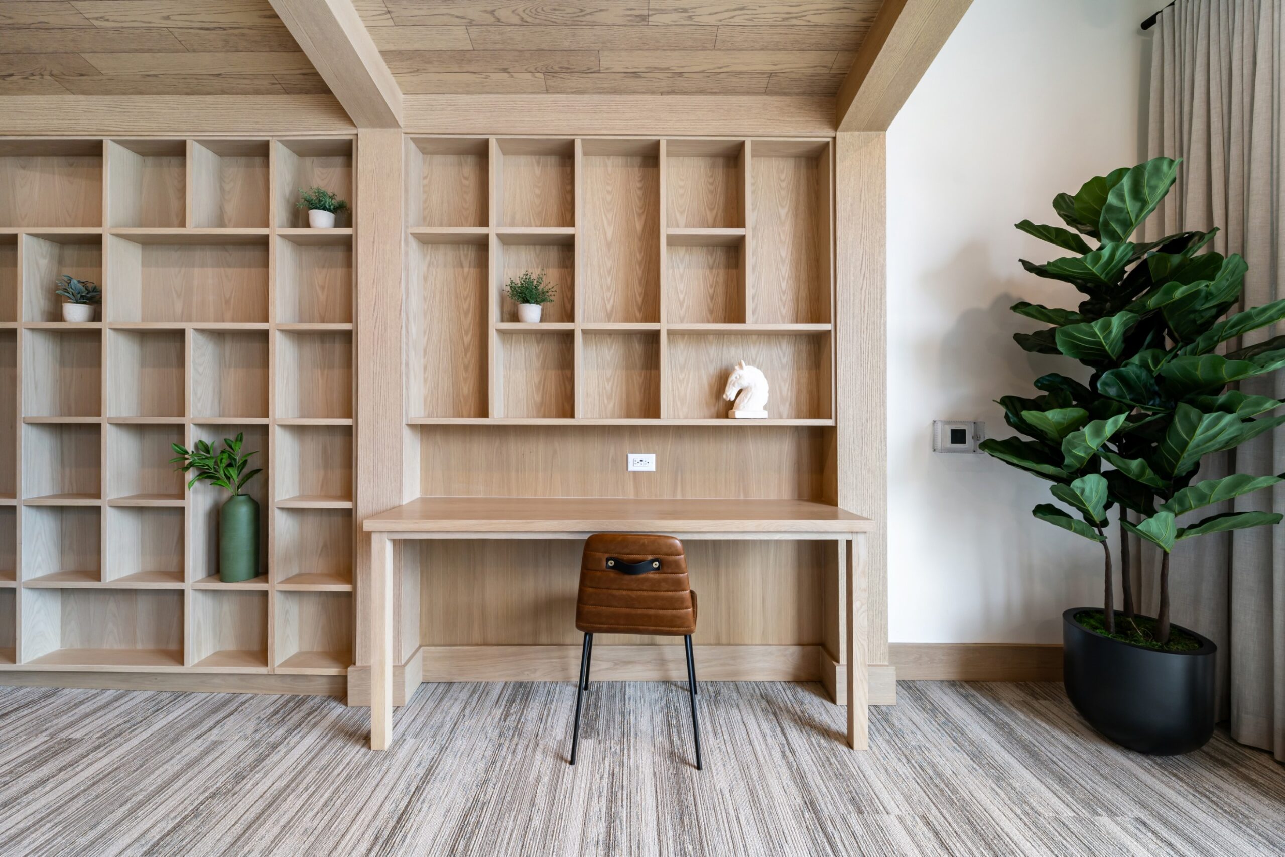 Coworking space with bookshelves and desk at Banyan High Point