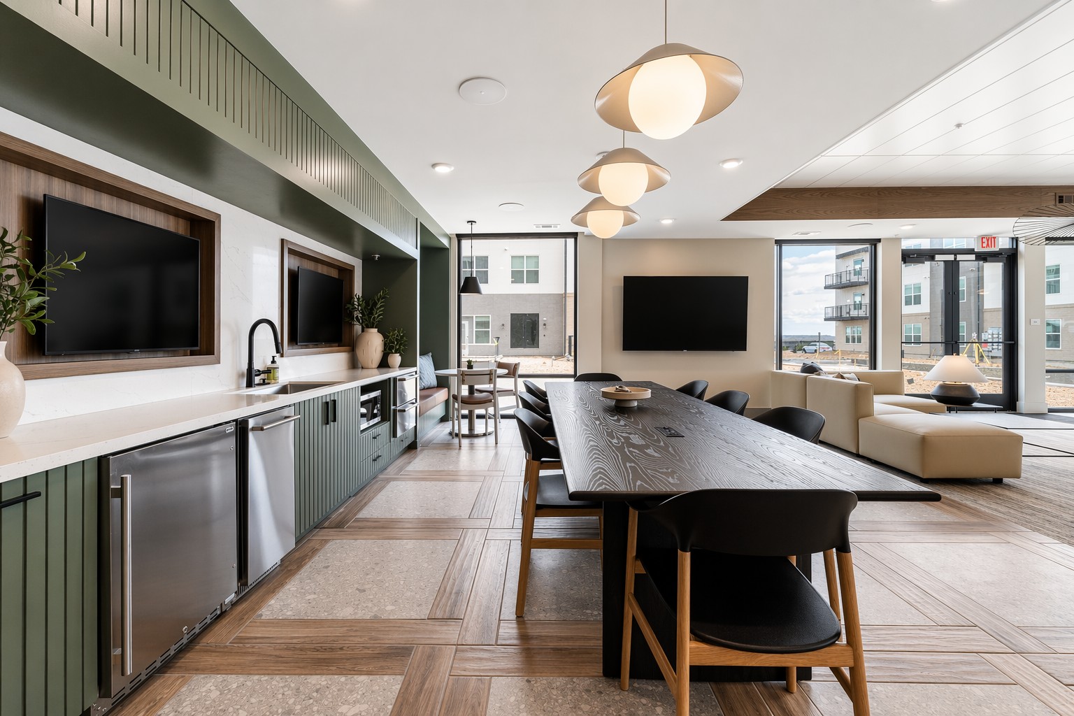 Community kitchen with flatscreen TVs at Banyan High Point