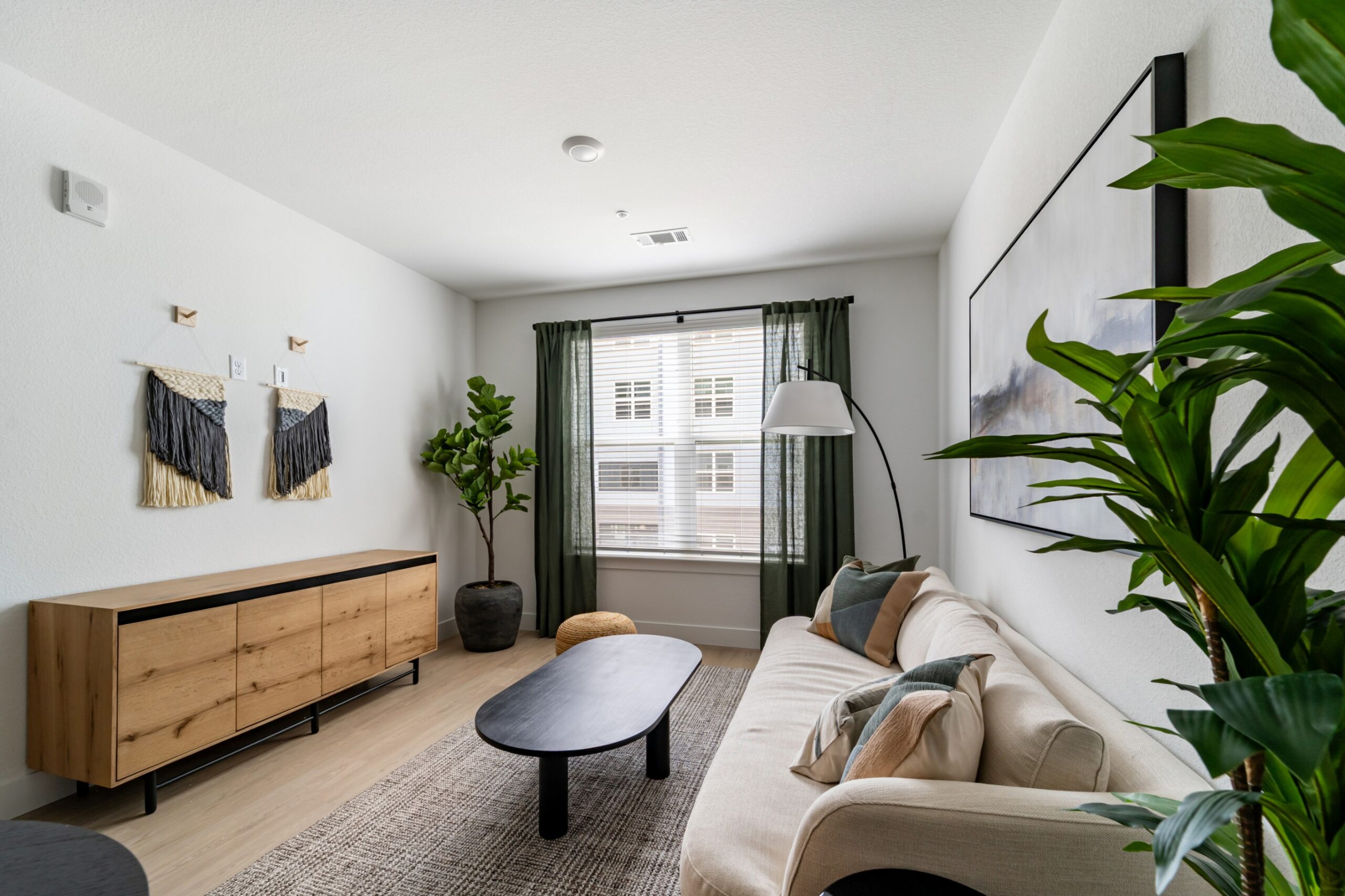 Model living room with natural lighting and wood-style flooring